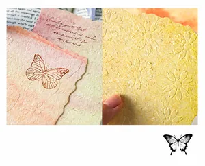 Macro shot of embossed vintage paper featuring butterfly and daisy textures for DIY scrapbooking