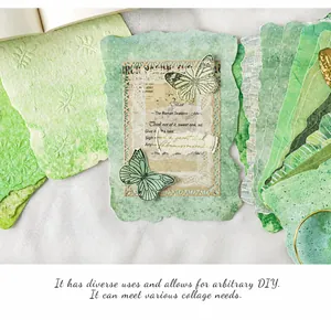 Detail of vintage green scrapbooking papers with embossed textures and butterfly accents