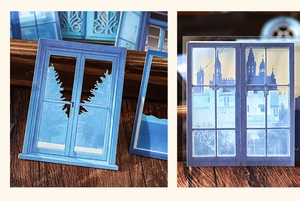 Detalle de recortes de papel de ventanas azules con siluetas para decoración de álbumes