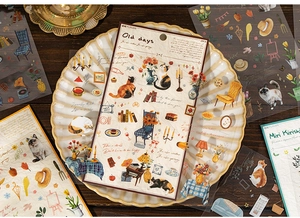 Gros plan de stickers vintage motifs chats et meubles sur une table en bois