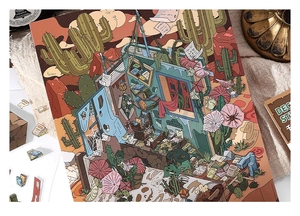 Macro shot of creative desert landscape stickers with vintage book architecture on linen