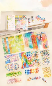 Artistic watercolor aesthetic scrapbooking kit with stickers and gradient papers on beige fabric