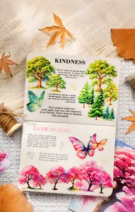 Creative scrapbook layout featuring forest scenery stickers and gold butterfly accents