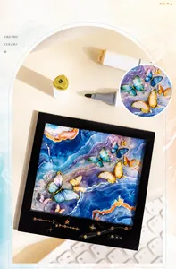 Detail of artistic butterfly stickers with gold foil constellations on marble background