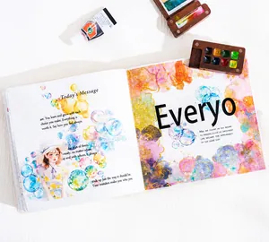 Detail of watercolor bubble stickers and hand-drawn figures on a DIY scrapbook page