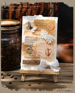 Macro detail of vintage coffee themed lace scrapbooking paper on a wooden easel