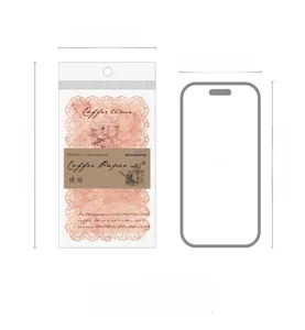 Lace hollow material paper for vintage scrapbooking beside a phone for size comparison