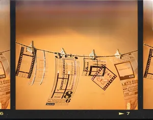 Close-up of vintage film frame PET stickers hanging on rope in warm sunset lighting