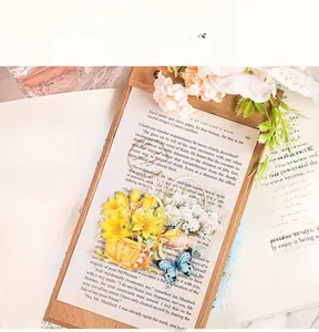 Detailed PET floral stickers featuring a yellow lily basket and blue butterfly on a notebook