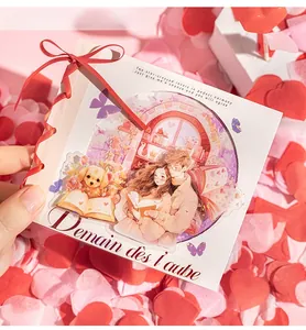 Detailed view of DIY romantic couple sticker card with red ribbon and heart confetti