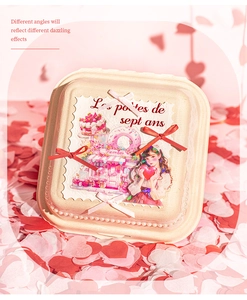 Detail of cream gift box with vintage girl stickers, pink ribbons, and heart decor