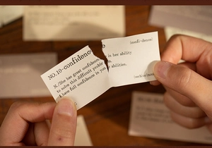 Close-up of vintage aesthetic English word card showing dictionary definition of confidence