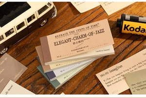 Macro view of vintage style jazz themed decorative scrapbooking paper set on a wooden desk