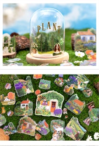 Close-up of European cottage and floral stickers on mossy background for DIY journals