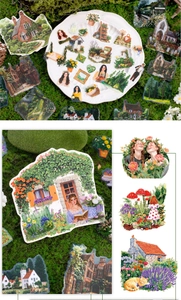 Macro detail of vintage cottagecore stickers featuring rural cottages and garden flowers