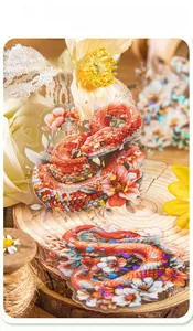 Detail of red snake and flower stickers with shell light finish and oily texture