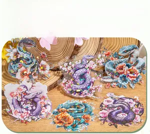 Holographic snake and floral stickers on wooden background for DIY journaling