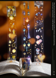Detail of die-cut PET tape featuring vintage lamp illustrations and star patterns over a book