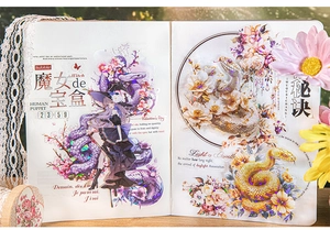 Creative snake and flower themed craft stickers applied on a notebook page decoration