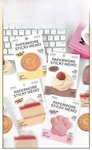 Close-up of four bakery themed sticky notes including cookie and mousse designs on a desk