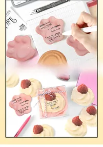 Detailed view of pink cat paw shaped sticky notes with inspirational English text
