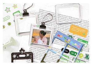 Close-up of acrylic photo frame keychains with star prints and blue decorative patterns