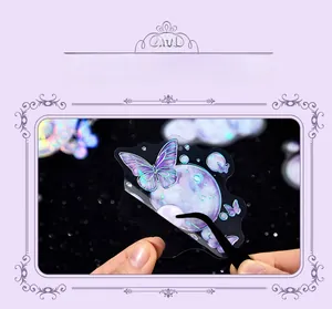 Detailed view of translucent butterfly PET sticker being peeled with tweezers