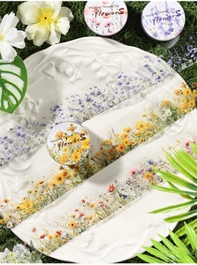 Detail of floral washi tape with pink and yellow wildflowers on a textured white plate