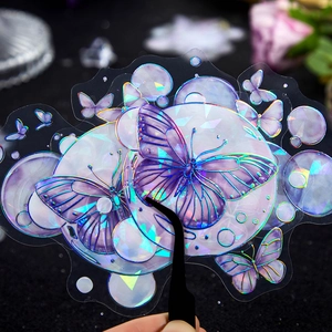 Iridescent butterfly stickers with holographic laser coating on a textured black surface