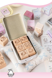 Close-up of cute animal beech wood stamps and a metal storage box for journaling