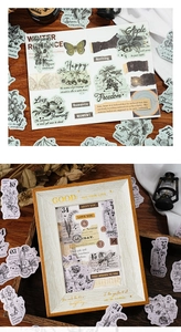 Detail of vintage scrapbooking stickers with botanical and butterfly patterns on wood