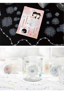 Macro shot of glittery fireworks and anime girl stickers on a glass cup for DIY scrapbooking