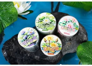 Detailed view of summer lotus theme washi tape with watercolor floral patterns on dark rock