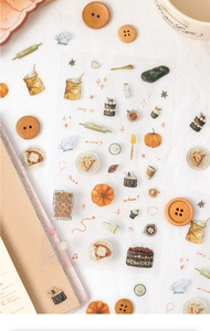 Close-up of watercolor baking stickers with hand-drawn cakes and autumn kitchen illustrations