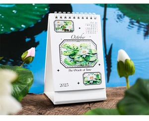 Detail of 2025 lotus desk calendar with white metal coil binding and floral illustration