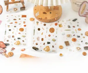 Close-up of PET stickers featuring warm coffee and dessert illustrations for DIY planners