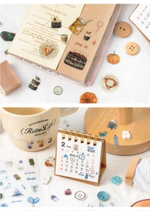 Detailed view of hand-drawn dessert and coffee PET stickers used on a vintage notebook