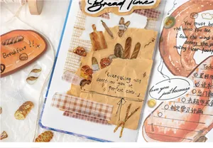 Close-up of hand-drawn bakery PET stickers with croissant and bread designs on a journal
