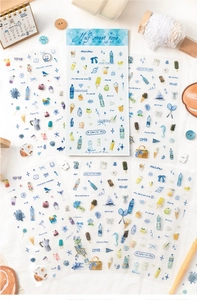 Close-up of summer themed PET stickers with blue cocktail and sea life motifs for scrapbooking