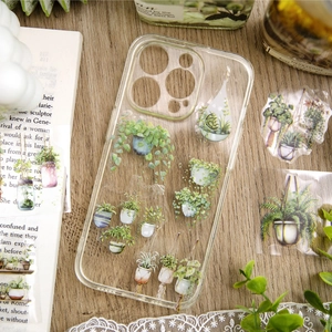 Custodia trasparente per smartphone con illustrazioni di piante in vaso su tavolo in legno