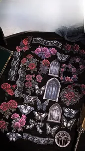 Gothic style scrapbooking stickers with black roses and dark lace on vintage wooden background