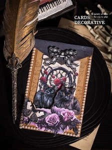 Gothic scrapbooking card with black cats, purple roses, and dark academia desk props