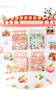 Close-up of PET botanical stickers with cute fruit motifs and vintage keyboard setup