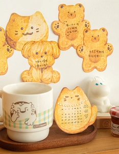 Close-up of cute animal shaped sticky notes with warm caramel cookie style textures