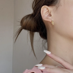 Vertical stacked gold egg-shaped bead earrings in S925 silver shown on model's ear