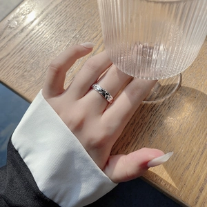 Detailed view of an irregular texture 925 sterling silver ring on a model's finger