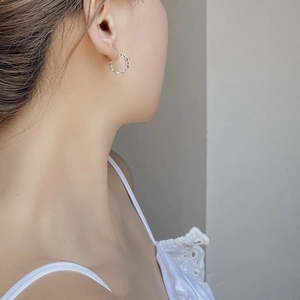 Minimalist S925 sterling silver hoop earrings with a beaded texture on female model