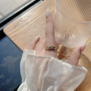 Elegant 925 sterling silver ring with irregular hammered texture on a model finger