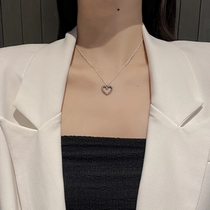 S925 sterling silver heart necklace with twisted rope texture worn over a white blazer
