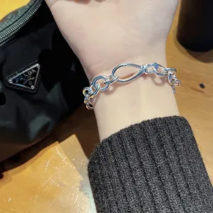 S925 sterling silver chain bracelet with infinity clasp worn on wrist with luxury vibes